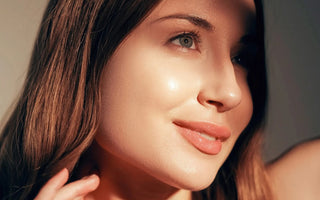 Woman with glowing skin sipping herbal tea in natural morning light – skin wellness with turmeric, tulsi, and moringa.